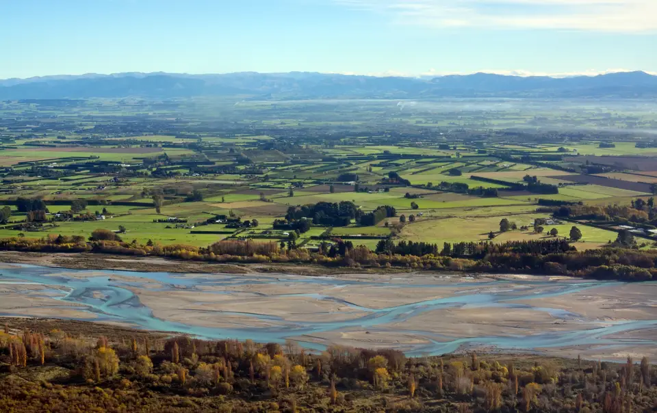 River flat and valley under a blue sky